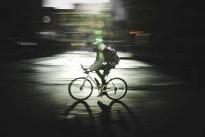 Man on bicycle; image by S (@projct33), via Unsplash.com.