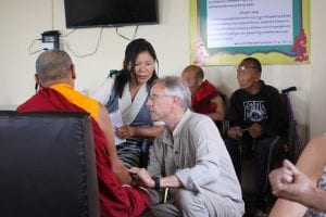 Buddhist monk being seen by doctor; image by Delfynn Aldag, via Unsplash.com.