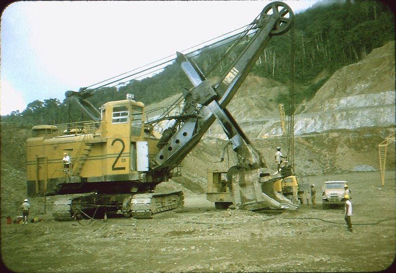 A giant earthmoving machine rests in a barren copper mine that once was home to natives of Bougainville.