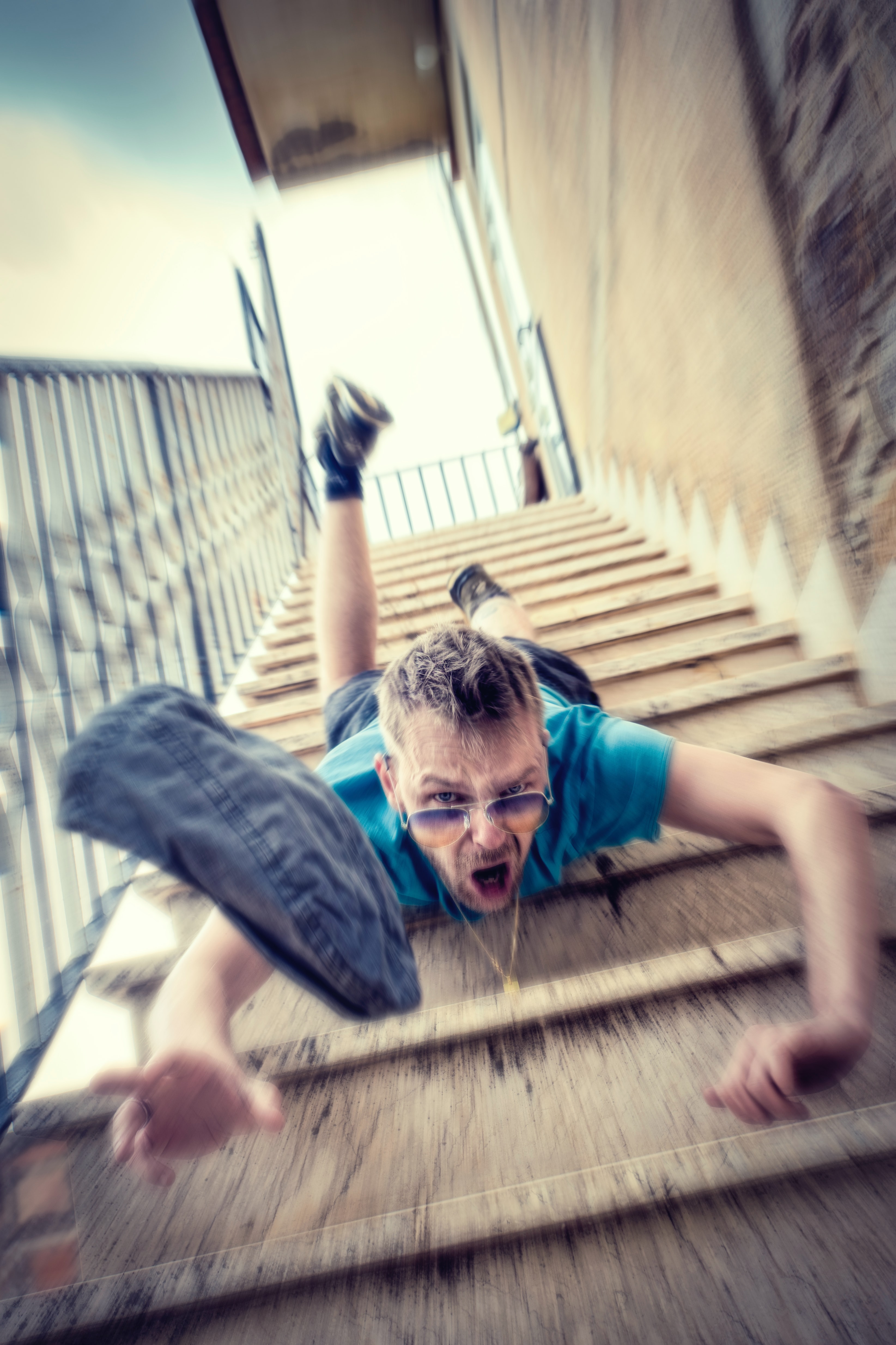 Man falling down stairs; image by Sammy Williams, via Unsplash.com.