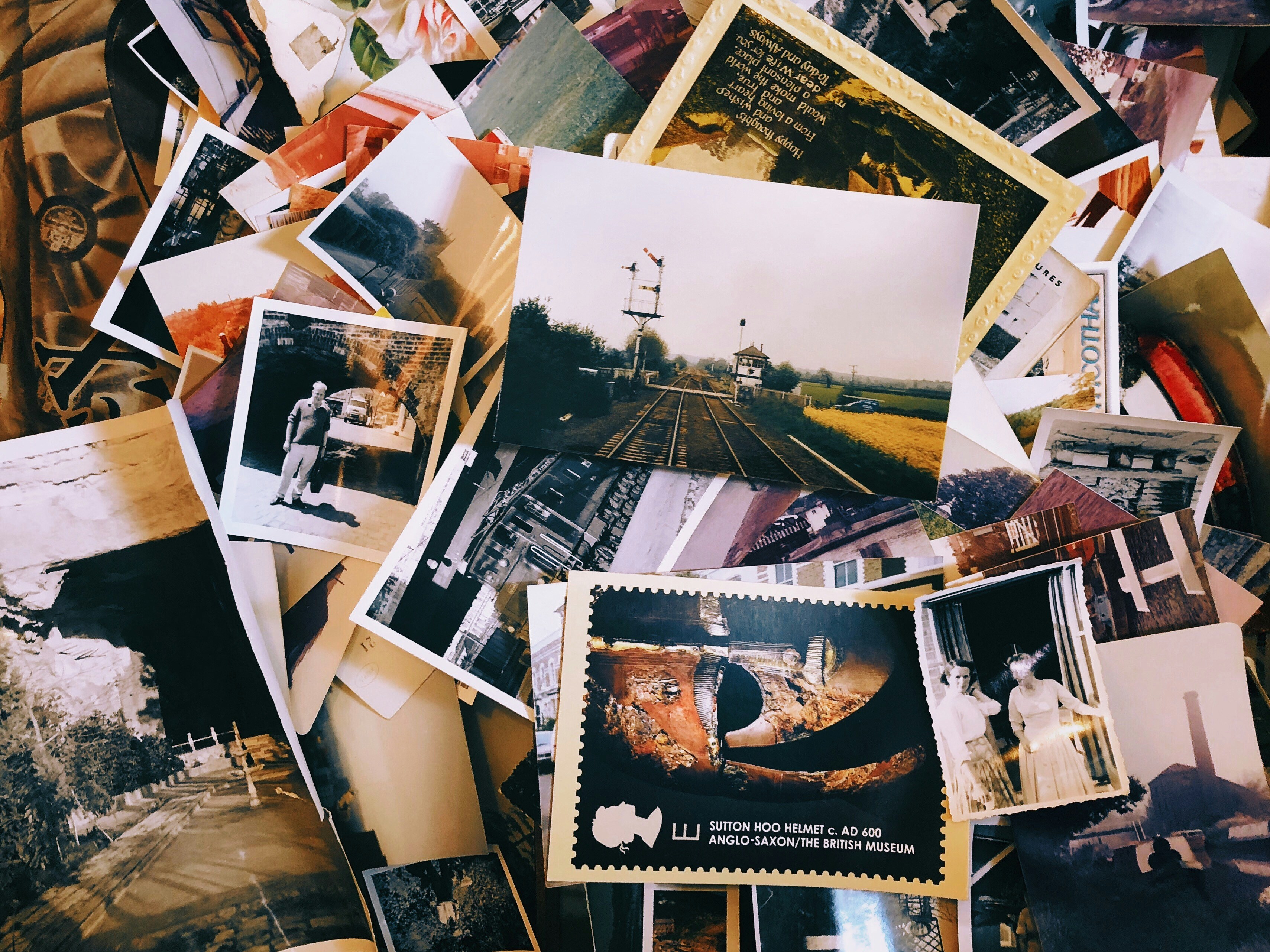 Pictures and postcards piled on each other; image by Jon Tyson, via Unsplash.com.