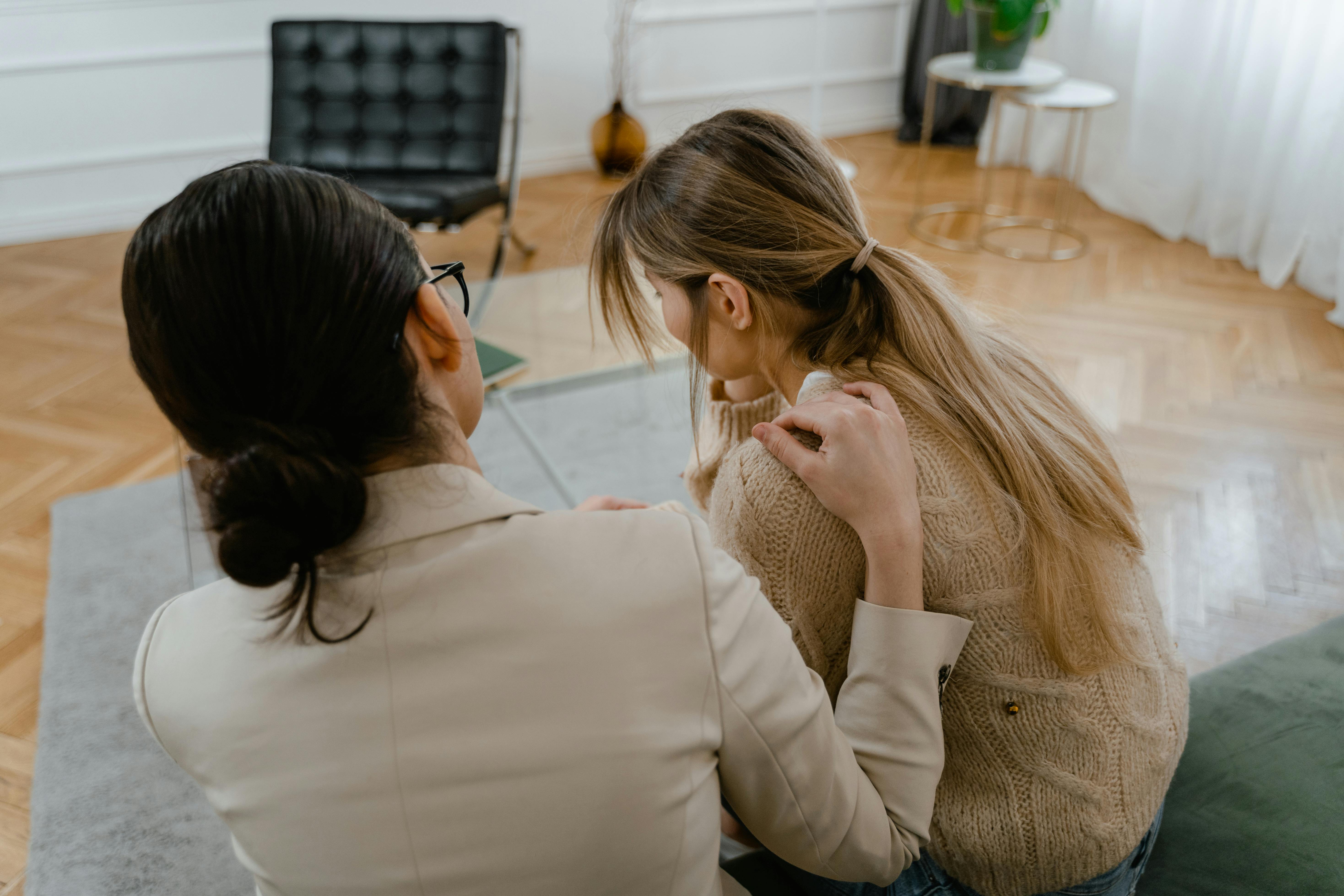 Lawyer comforting her client; image by Mart Production, via Pexels.com.