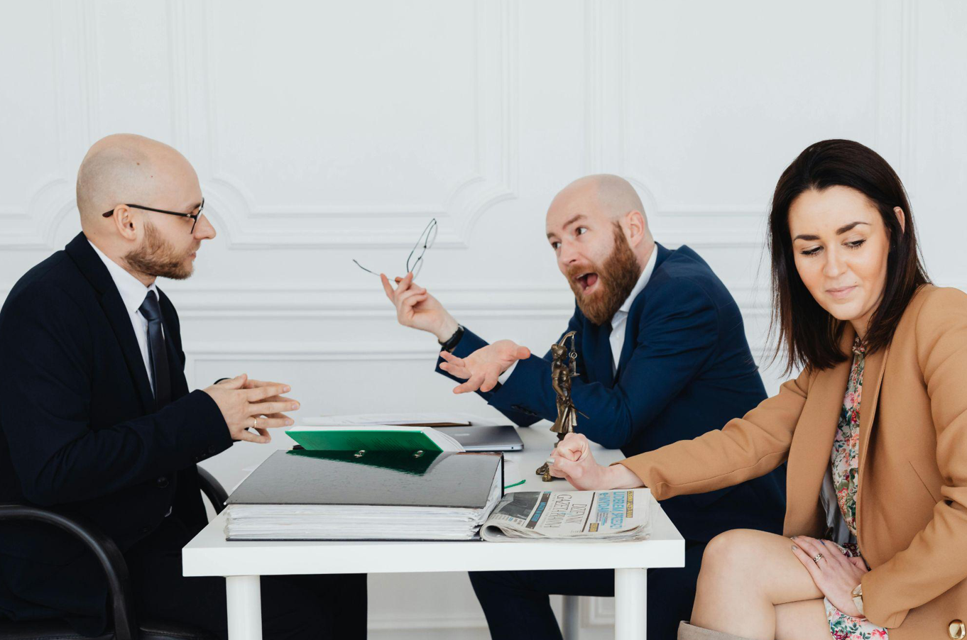 Man arguing with lawyer, woman looking embarassed; image by Karolina Kaboompics, via Pexels.com.