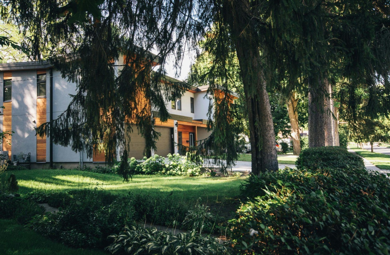 White painted house near green-leafed trees; image by Scott Webb, via Pexels.com.