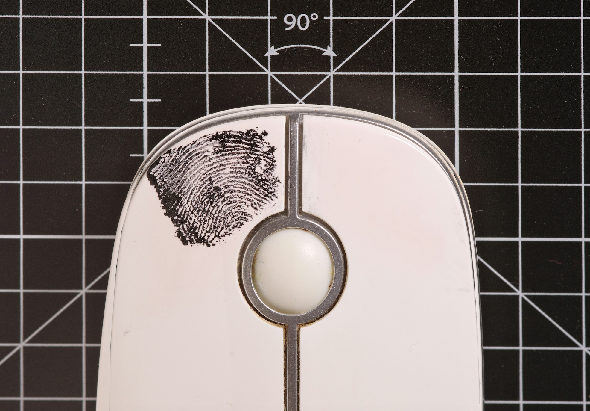 Fingerprint on computer mouse; image by Immo Wegmann, via Unsplash.com.