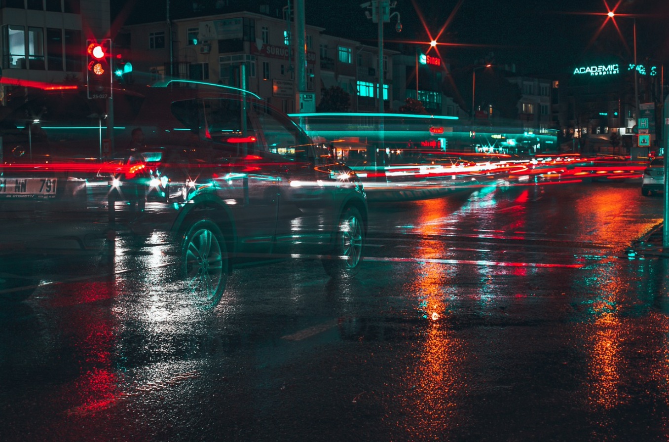 Half invisible car on wet city road at night; image by Pixabay, via Pixabay.com.