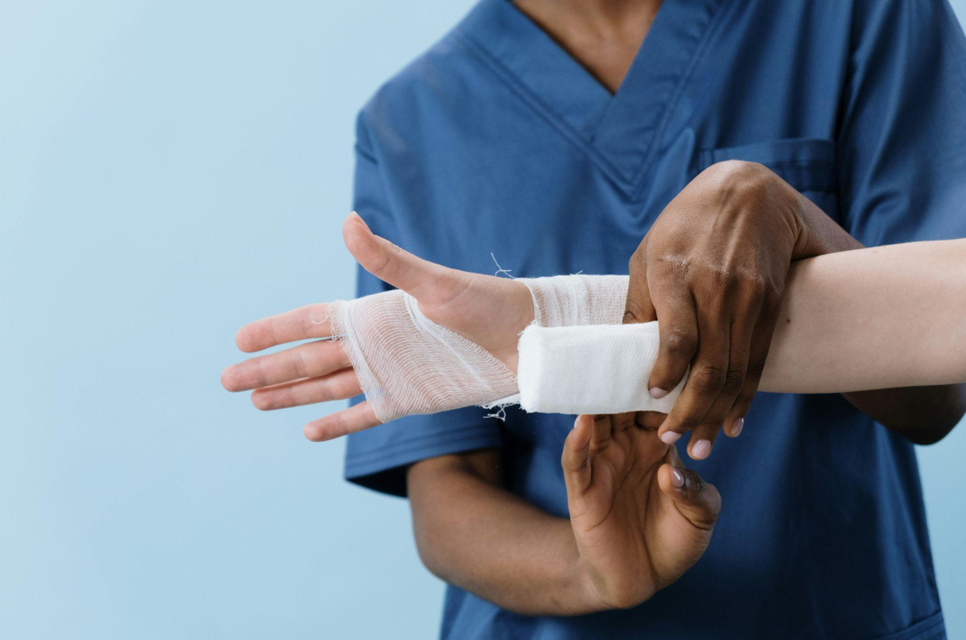 Person getting hand bandaged; image by cottonbro studio, via Pexels.com.