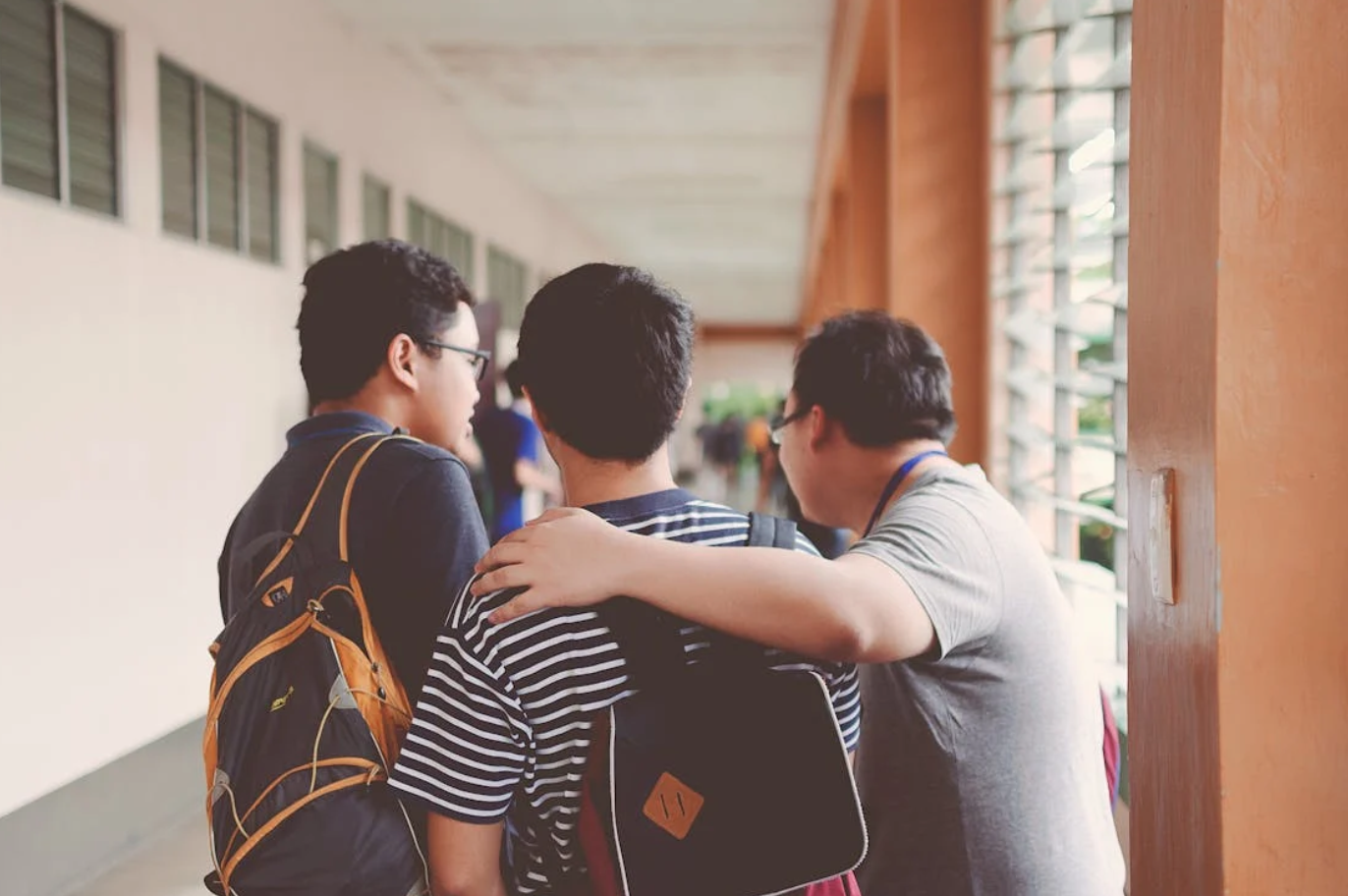 Three men standing near window; image by Kobe -, via Pexels.com.