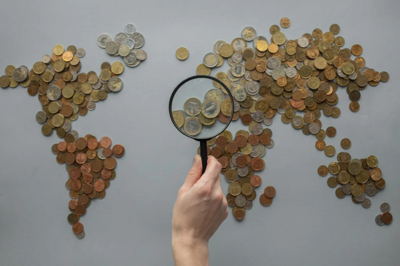 World map made from various coins; image by Monstera Production, via Pexels.com.