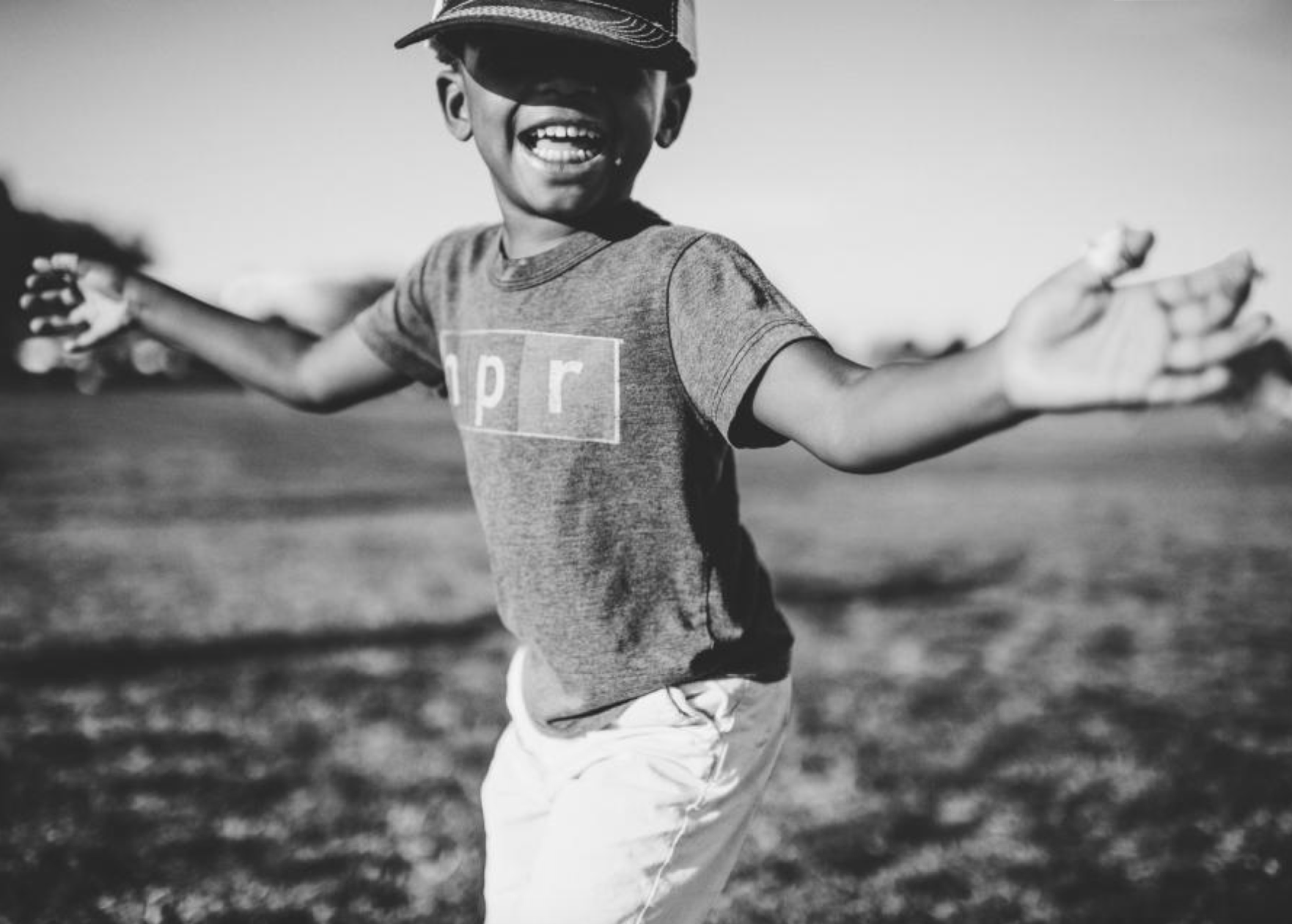 Black and white photo of child playing, palms outstretched; image by Frank McKenna, via FreeRangeStock.com, CC0 public domain.