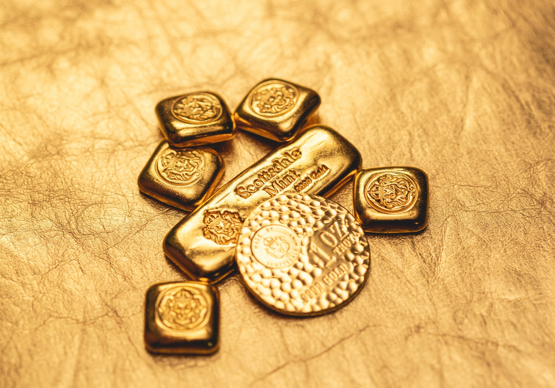 Collection of original gold bars and coin minted by Scottsdale Mint in Arizona. Image by Scottsdale Mint, via Unsplash.com.