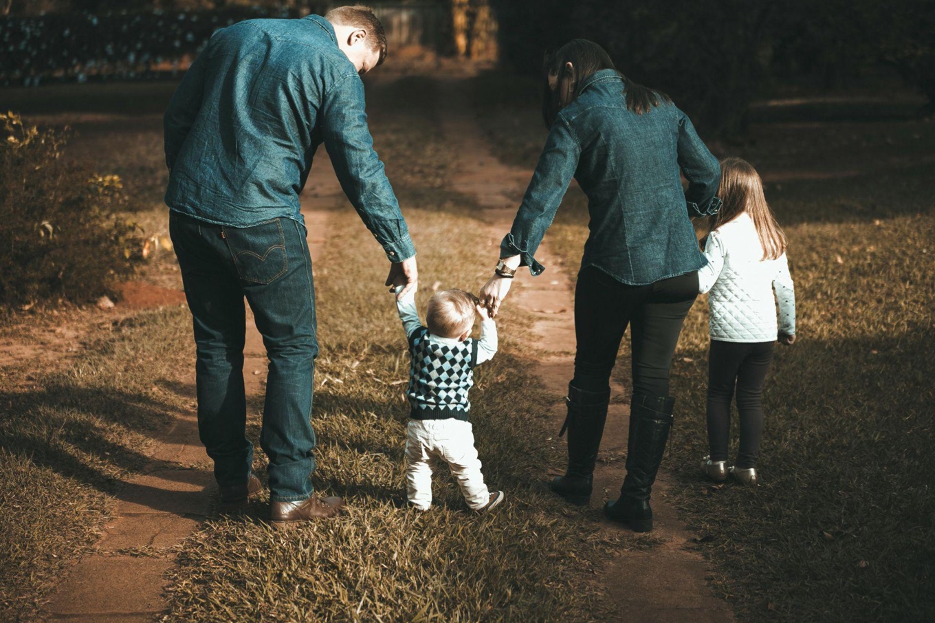 Family walking along path; image by Vidal Balielo Jr., via Pexels.com.