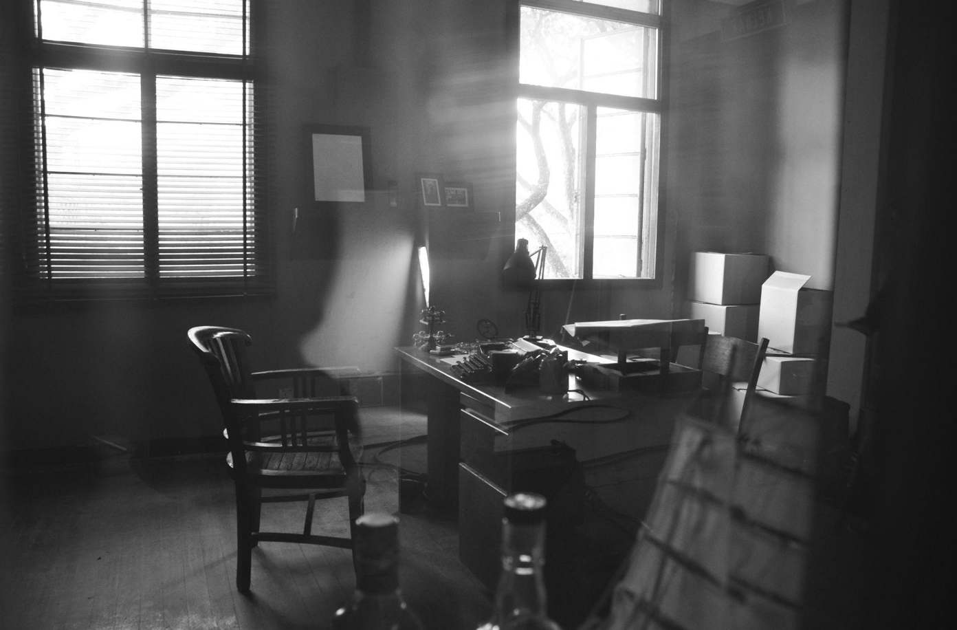 Greyscale shot of film noir detective's office; image by Michelle Ding, via Unsplash.com.