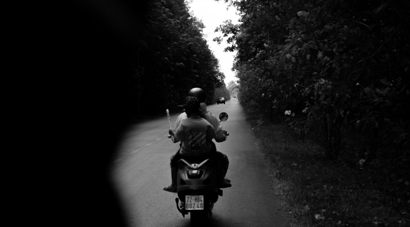 Two people on a motorcycle; image by Đăng Phan, via Pexels.com.