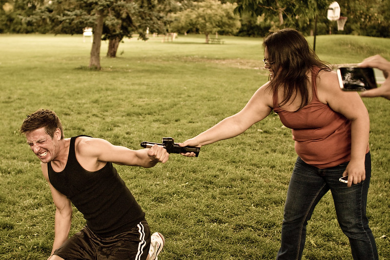 Woman hitting man with tool; image by Stepan Mazurov, via Flickr.com, CC BY-SA 2.0, no changes made.