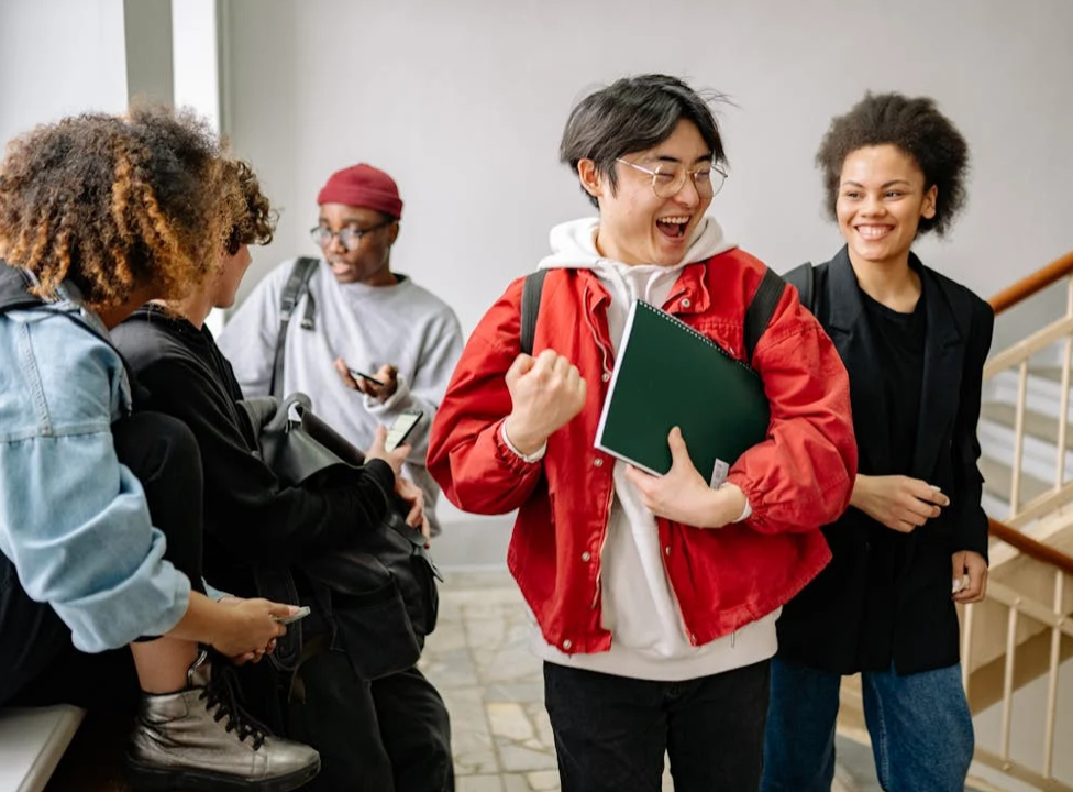 Students laughing and smiling together; image by Yan Krukau from Pexels.com.