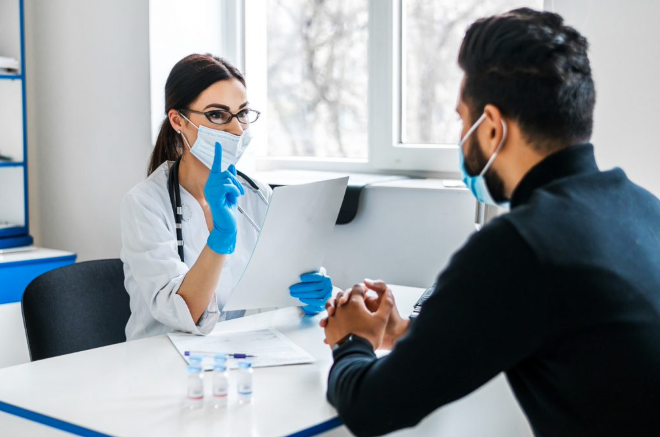 A female doctor consults her patient and holds documents in her hands; image by artursafronovvvv, via Freepik.com.