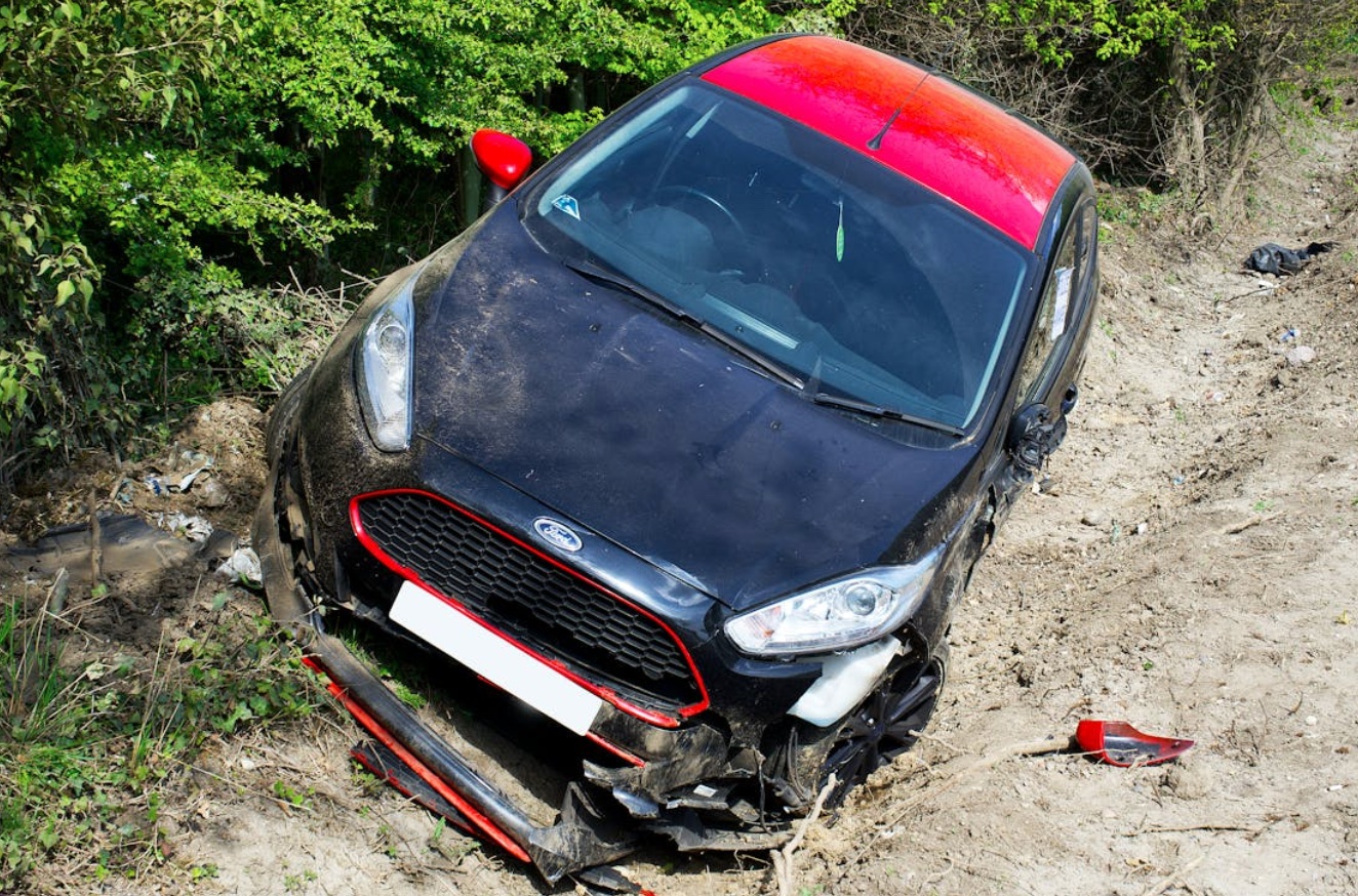 Car accident on dirt road; image by Mike Bird, via Pexels.com.