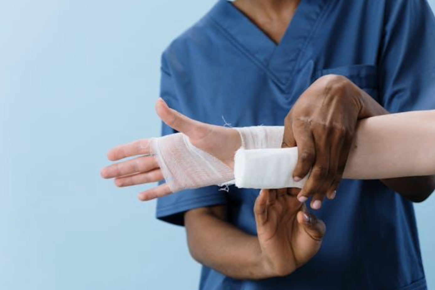 Person getting hand bandaged; image by cottonbro studio, via Pexels.com.