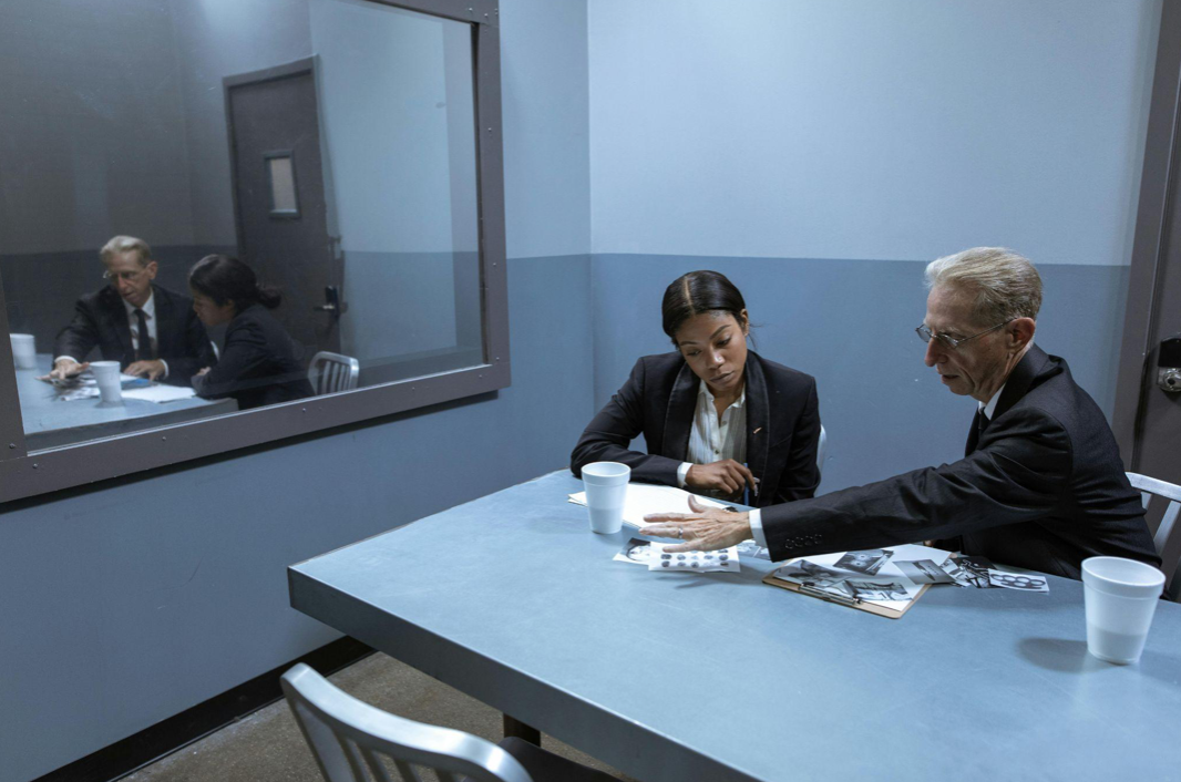 Two investigators at table reviewing evidence; image by RDNE Stock Project, via Pexels.com.